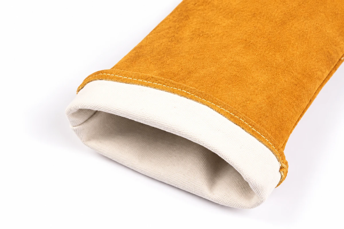Light fabric lining inside a tan leather welding glove cuff