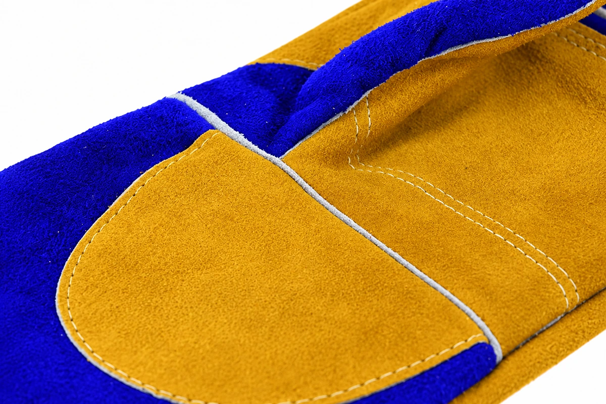 Double rows of stitching on a tan reinforcement panel over blue leather