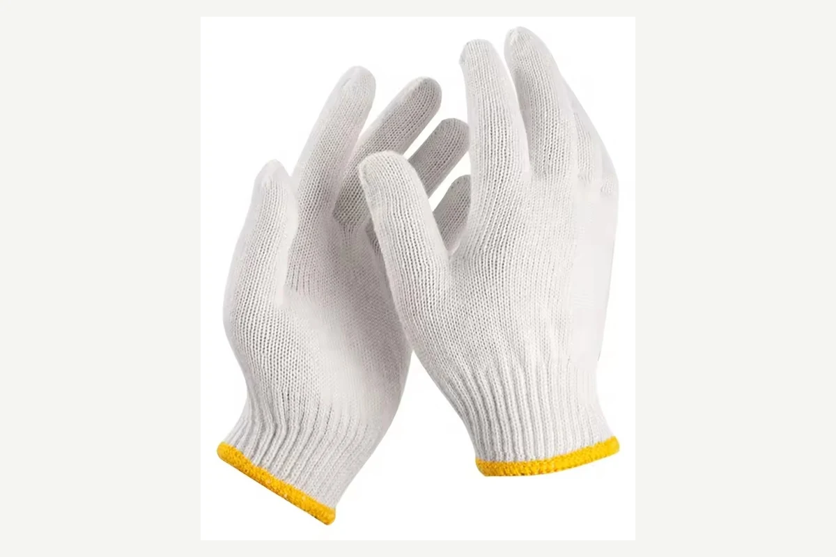 White knitted gloves with yellow-edged cuffs worn on both hands