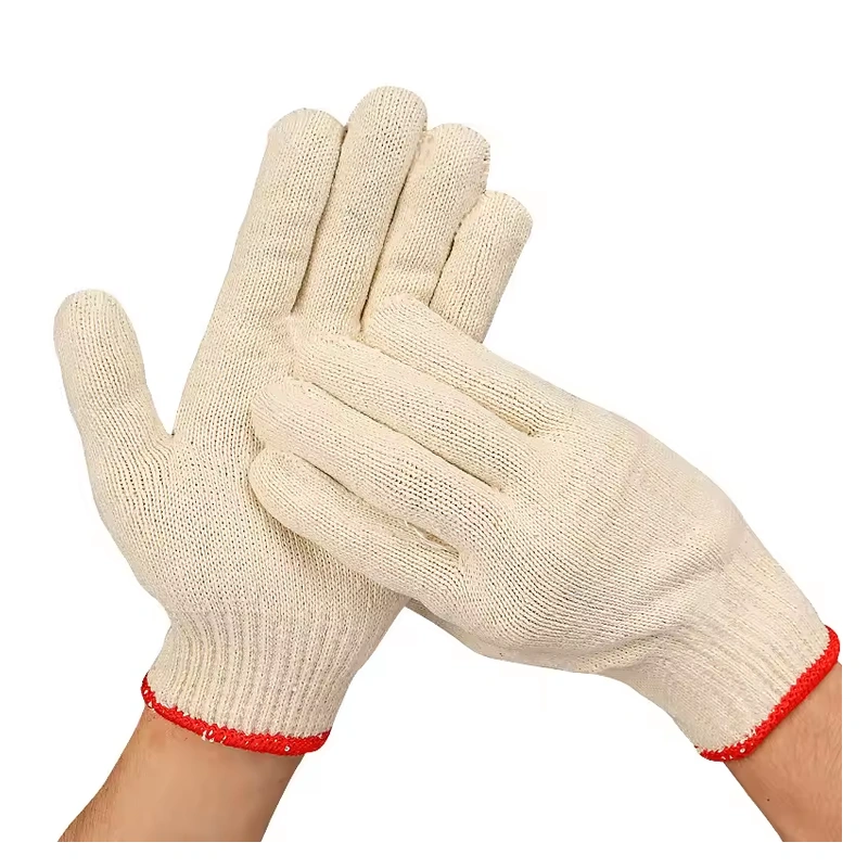 Cream knit gloves worn with red cuff edges and visible ribbed fingers
