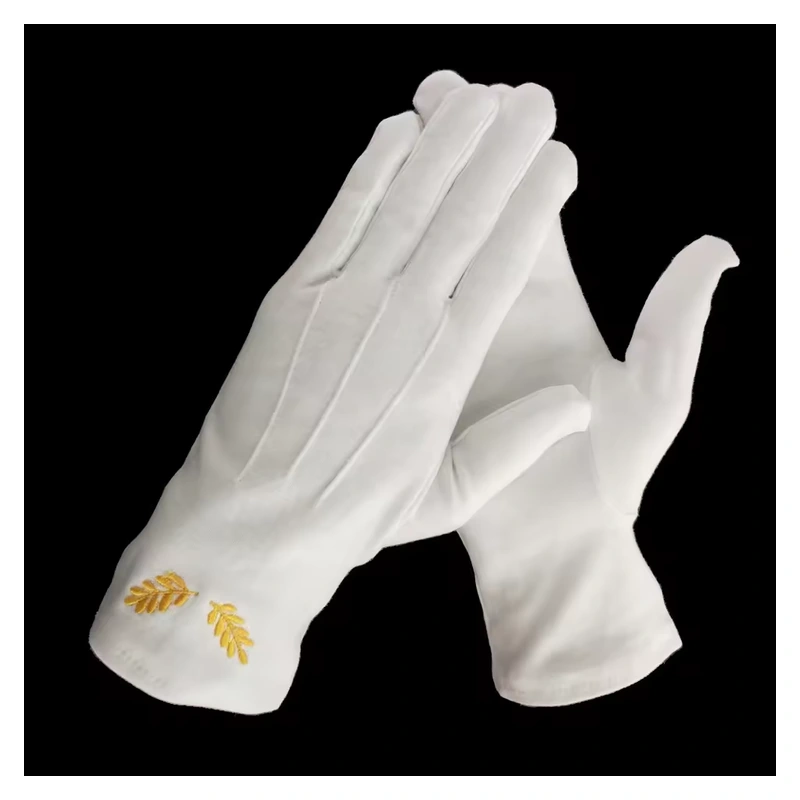 White gloves with small gold embroidered motifs on the cuffs