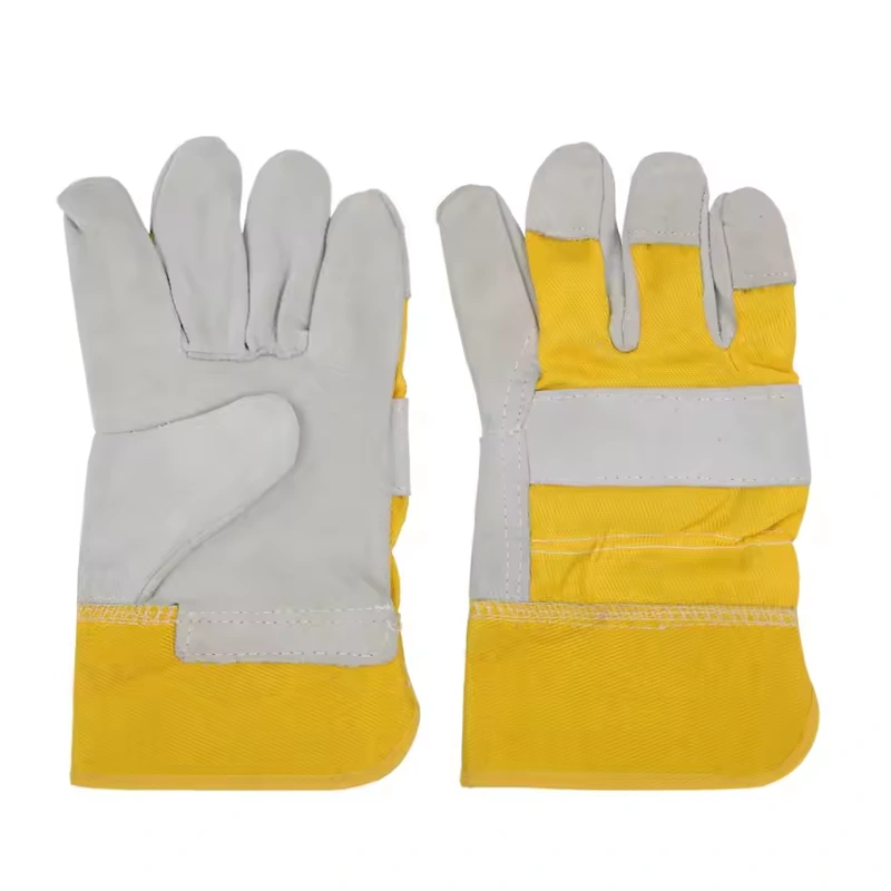 Gray work gloves with yellow fabric backs and wide cuffs